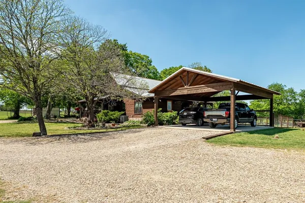 a view of a house with a yard and sitting area
