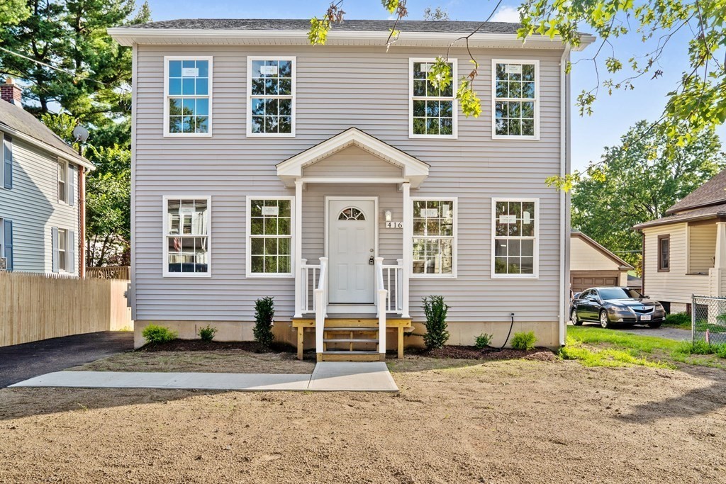 416 Nottingham Street Springfield, MA 01104 - Photo 1 of 20 a front view of a house with a yard and garage