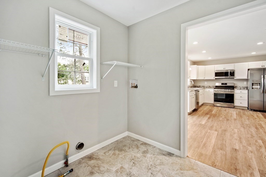416 Nottingham Street Springfield, MA 01104 - Photo 11 of 20 a view of kitchen with wooden floor electronic appliances and window