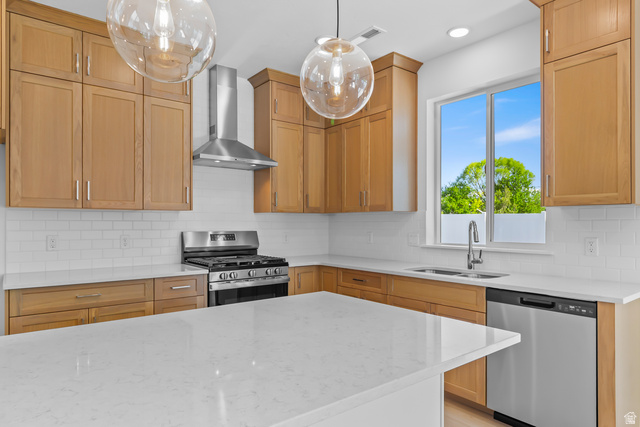1237 West 500 South, Unit 230 Logan, UT 84321 - Photo 9 of 42 Kitchen featuring natural wood cabinetry, white subway tile backsplash, stainless steel appliances, and a central island with a white countertop