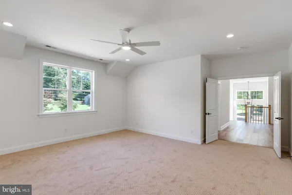 a view of a livingroom with a ceiling fan and window