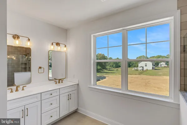 a bathroom with a double vanity sink and a window