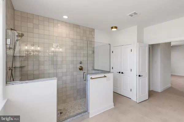 a bathroom with a shower and a sink