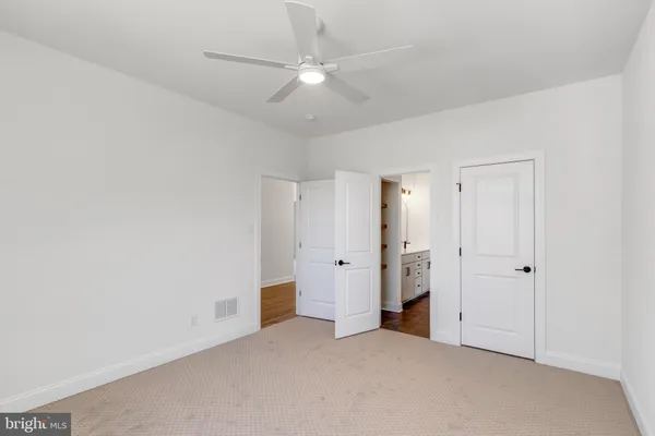 an empty room with a ceiling fan and a ceiling fan