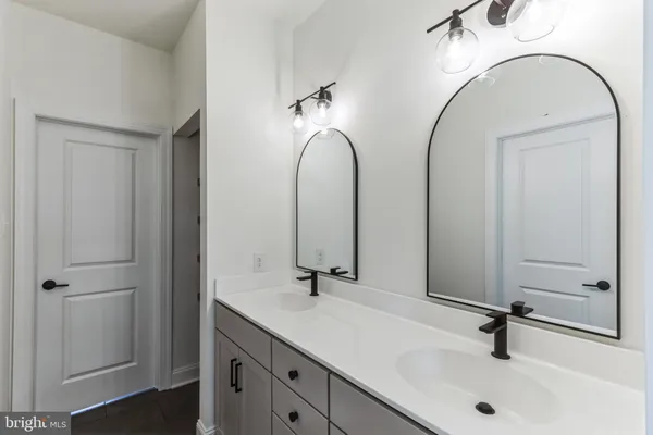 a bathroom with 2 sink and a mirror