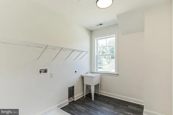 a view of a room that has a window and wooden floor