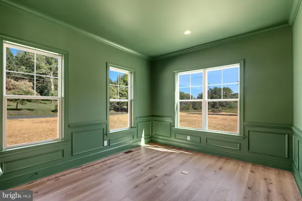 en empty room with window wooden floor and front door