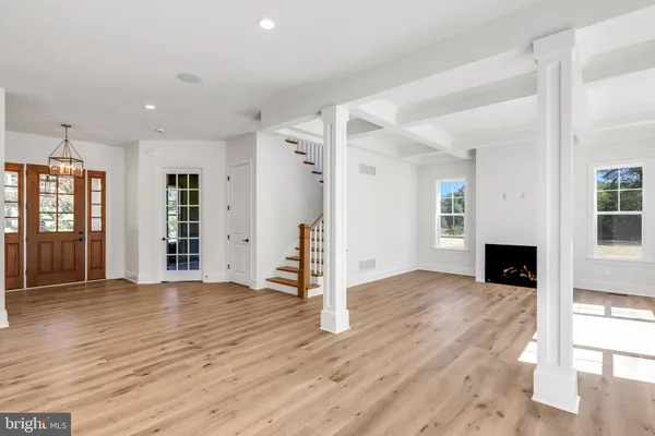 a view of a livingroom with wooden floor and staircase