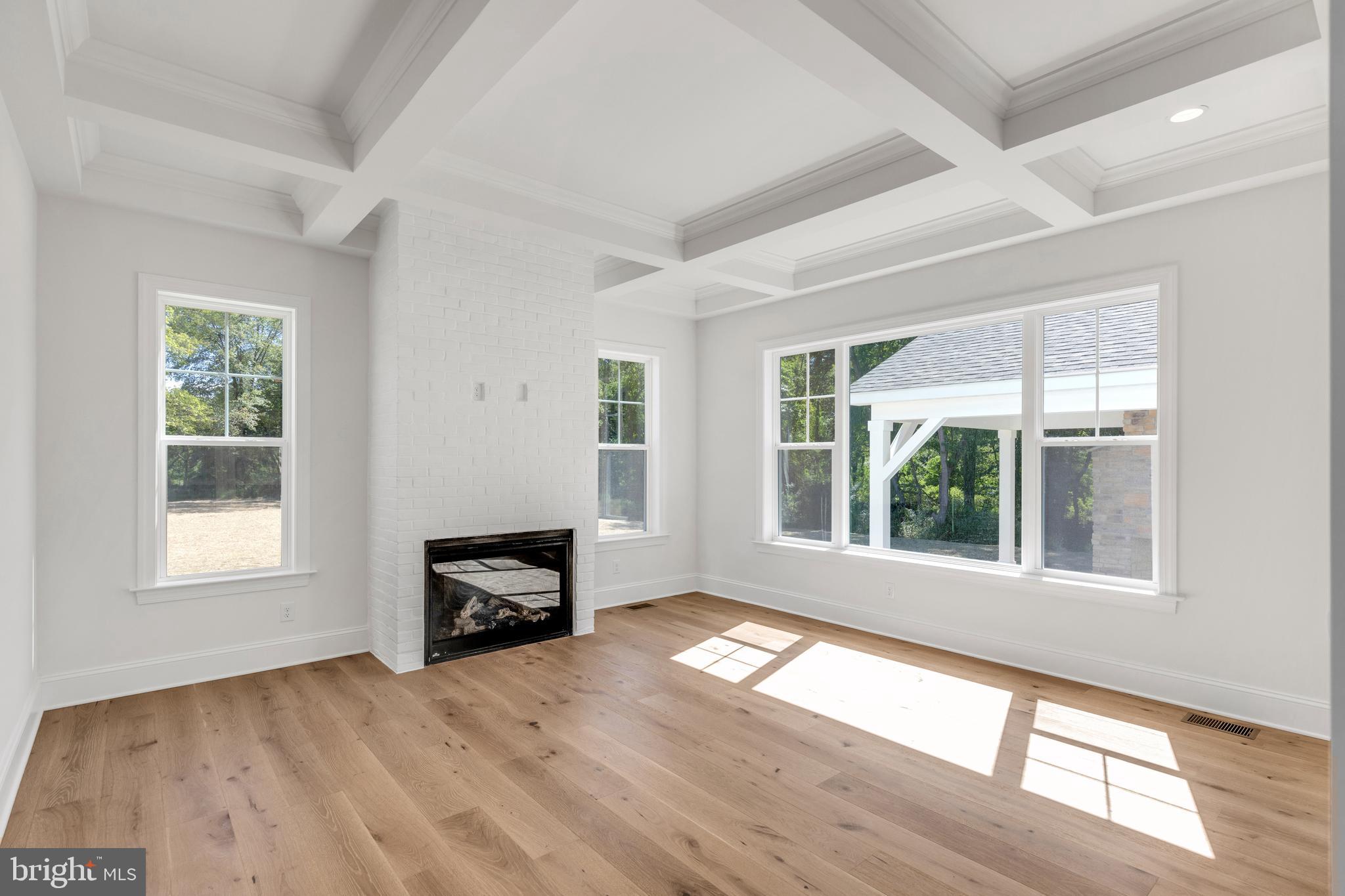 736 Northbrook Road, Unit S4 Kennett Square, PA 19348 - Photo 7 of 45 an empty room with windows fireplace and wooden floor