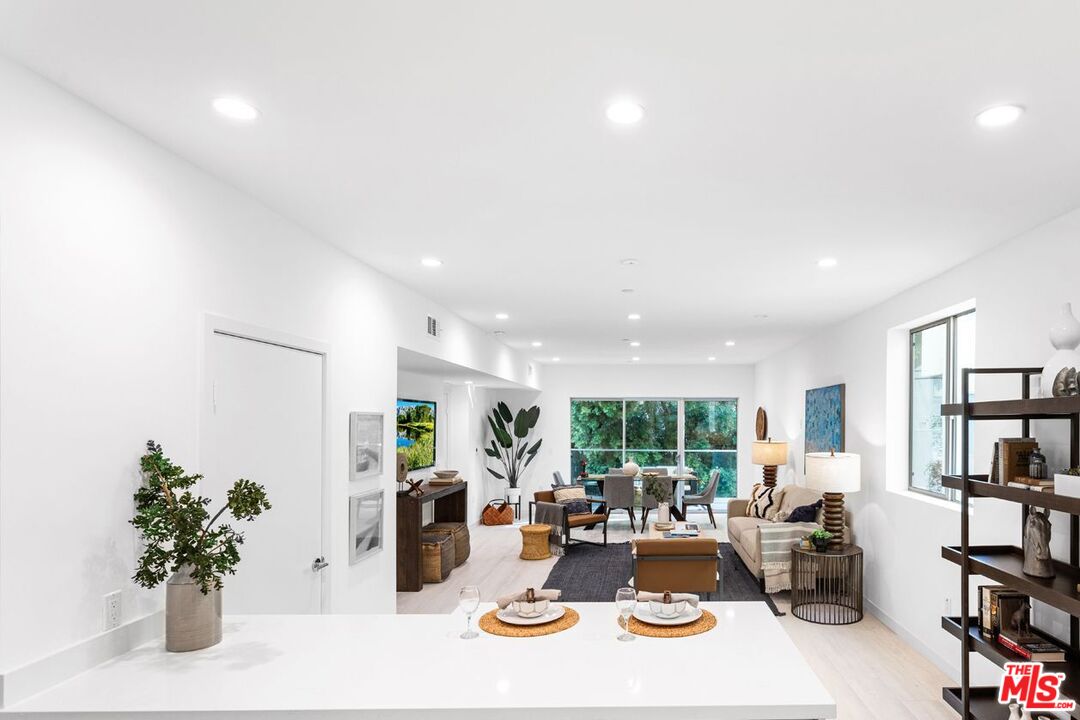 11620 Chenault Street, Unit 103 Los Angeles, CA 90049 - Photo 1 of 21 a room with furniture and a potted plant