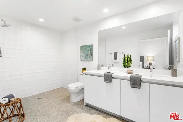 a living room with furniture a rug and a potted plant