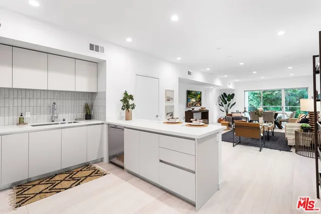 a large white kitchen with lots of counter top space