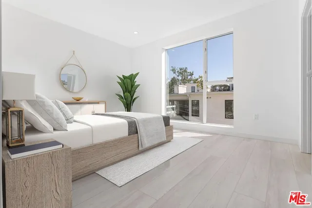 a living room with furniture fireplace and wooden floor
