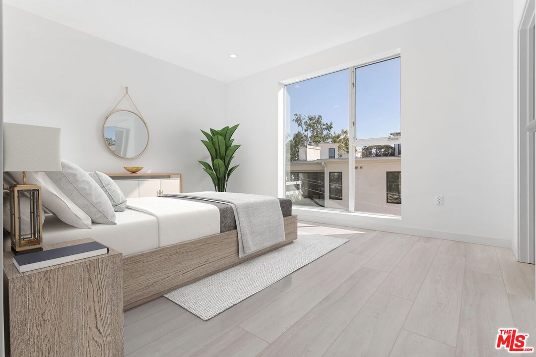 11620 Chenault Street, Unit 103 Los Angeles, CA 90049 - Photo 7 of 21 a living room with furniture fireplace and wooden floor