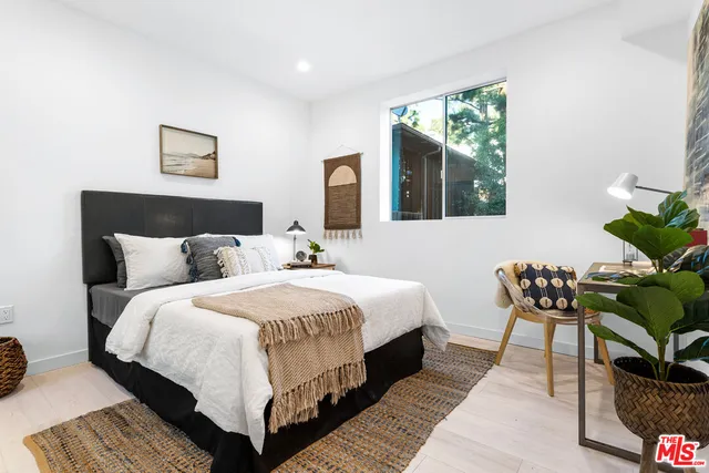 a bedroom with bed and a window