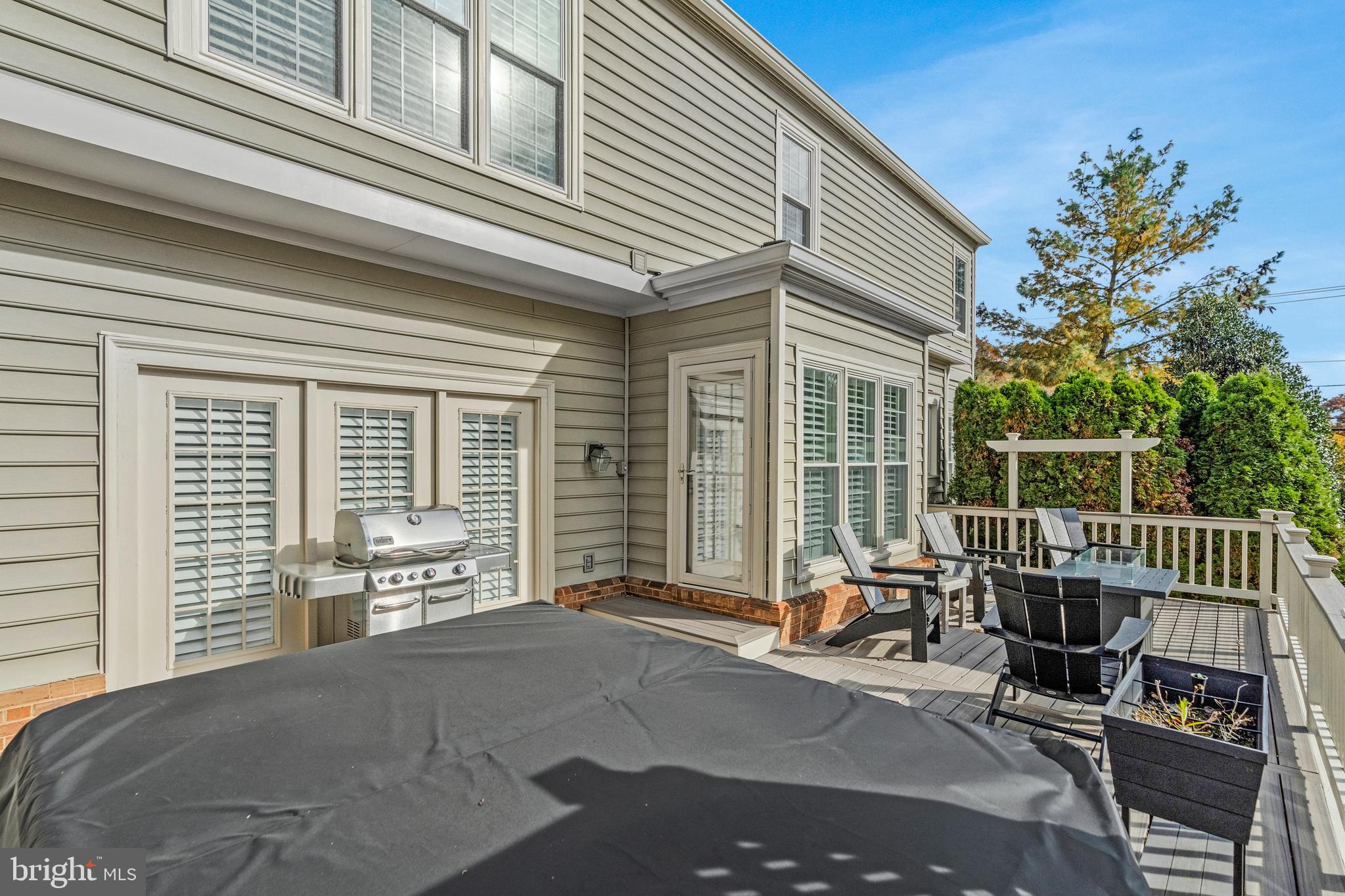 9733 Hidden Valley Road Vienna, VA 22181 - Photo 11 of 11 a view of a patio with a table and chairs and floor to ceiling window