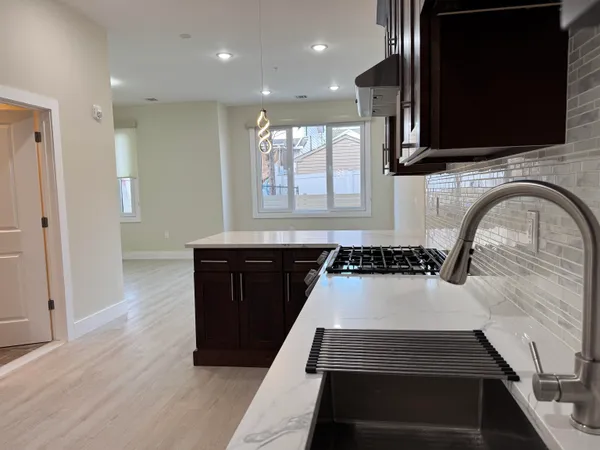 a kitchen with sink and cabinets