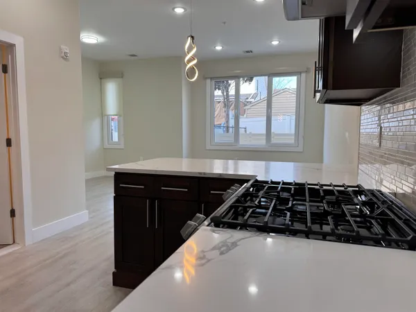 a kitchen with a sink and a stove top oven