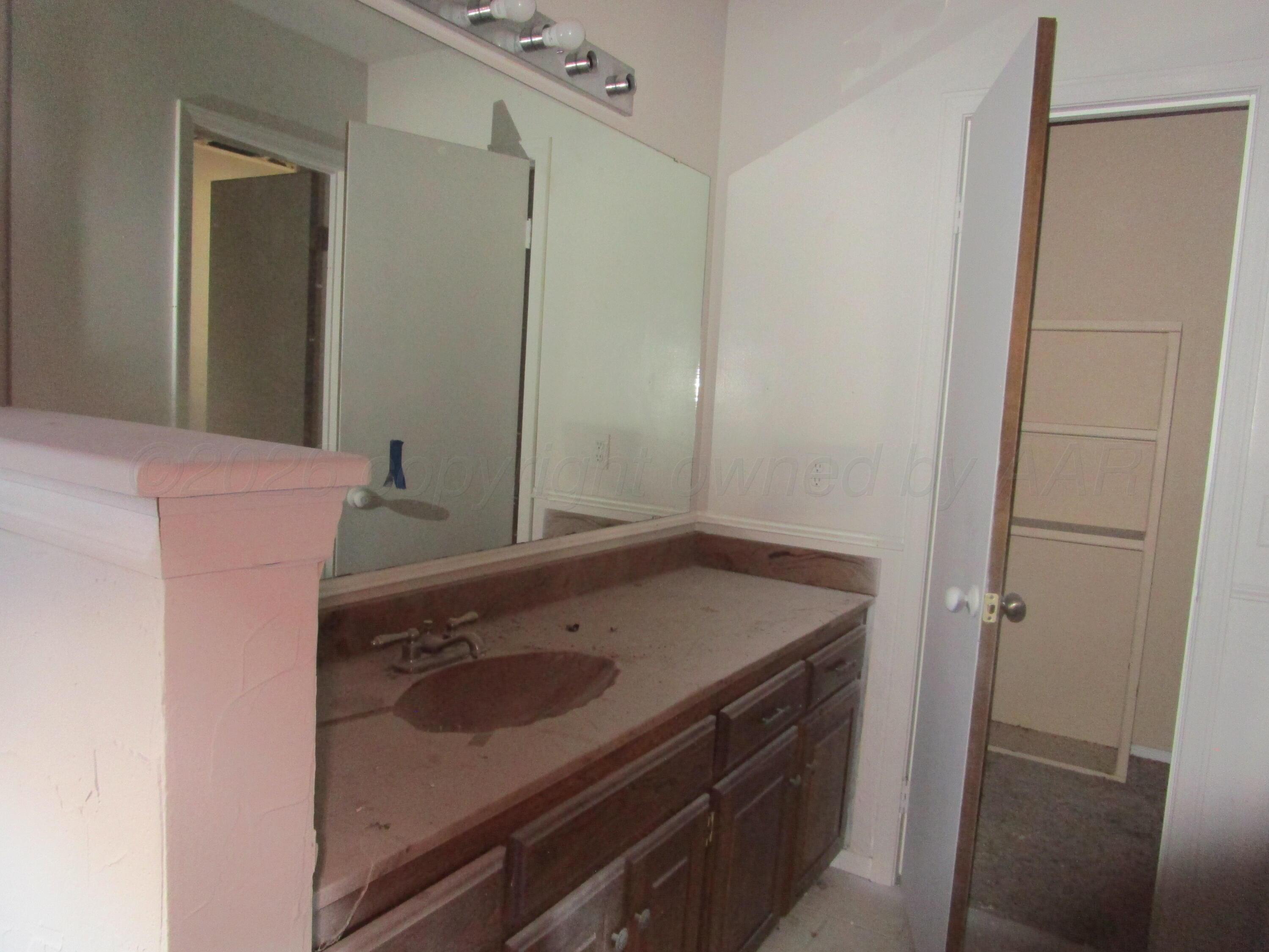 601 Alamo Street Claude, TX 79019 - Photo 19 of 30 a bathroom with a sink and a mirror