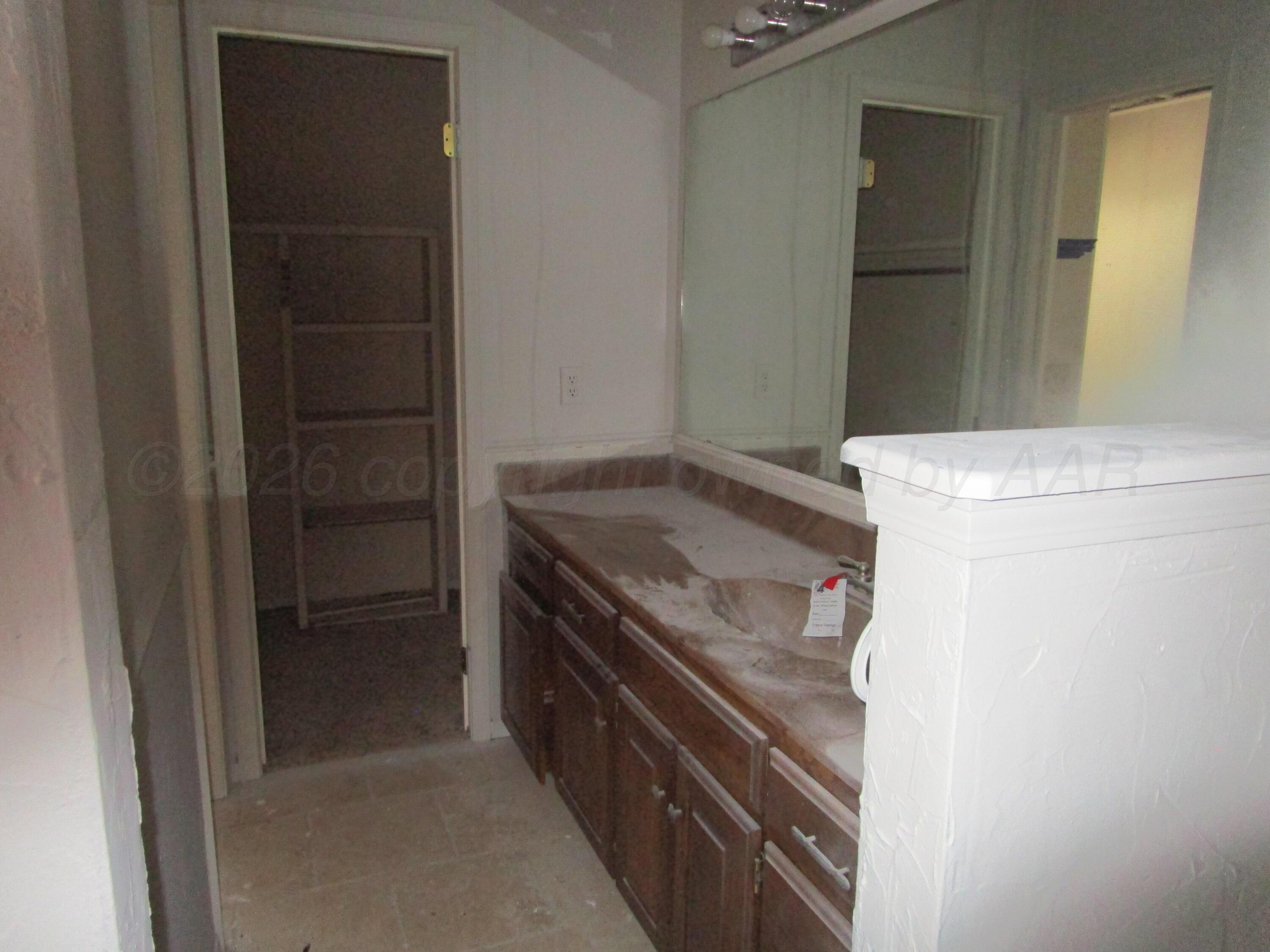 601 Alamo Street Claude, TX 79019 - Photo 20 of 30 a kitchen with a stove and a refrigerator