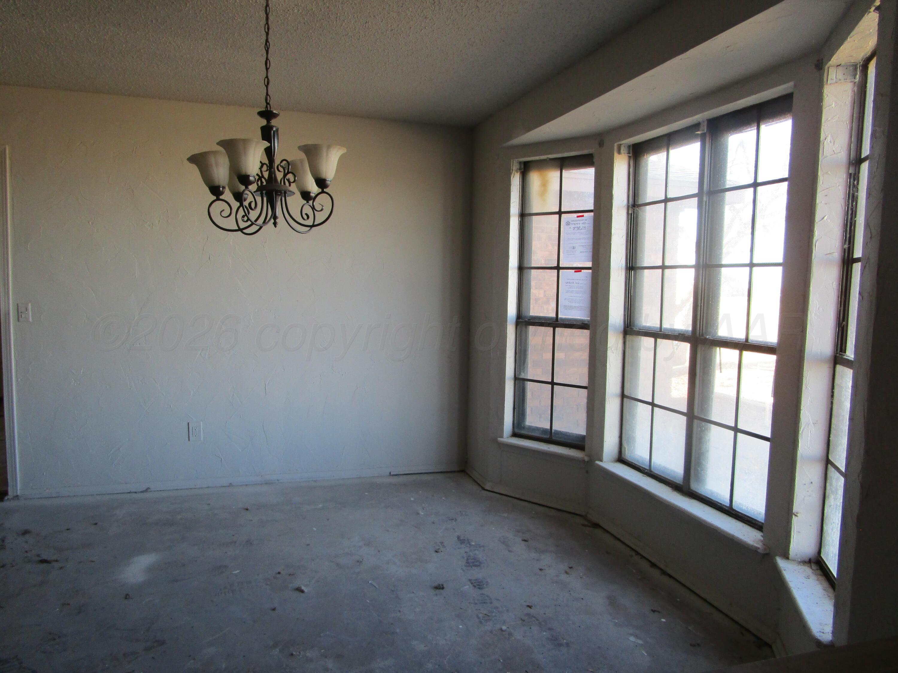 601 Alamo Street Claude, TX 79019 - Photo 4 of 30 a view of an empty room with a window