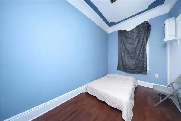a bedroom with a bed and a wall painting