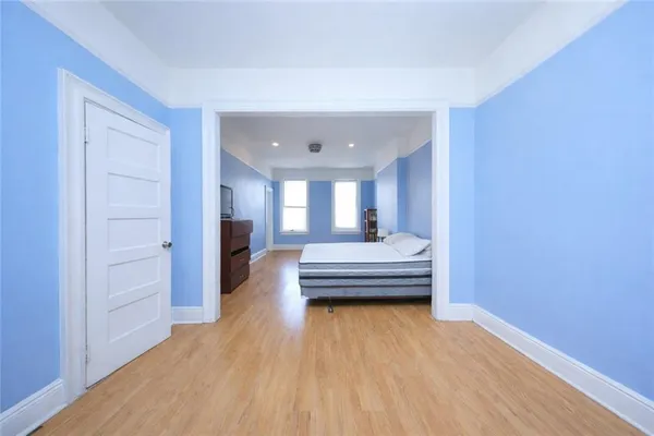 a view of a room with wooden floor and furniture