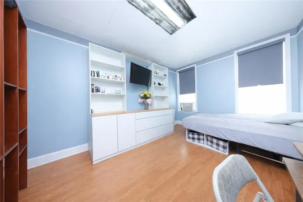 a room with a bed and a dresser