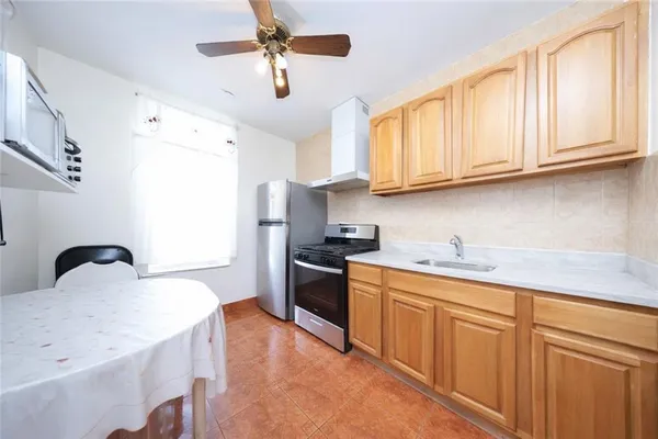 a kitchen with granite countertop cabinets stainless steel appliances and a sink