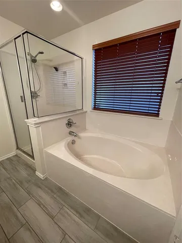 a bathroom with a bathtub and a shower