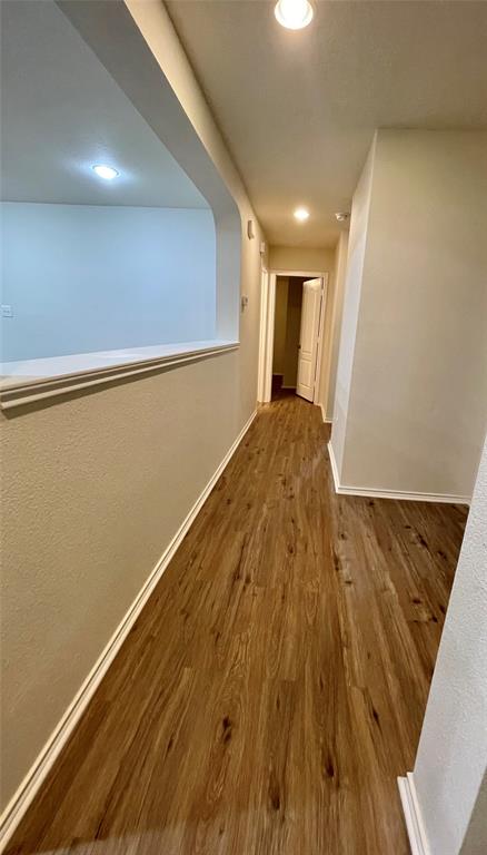 904 Watson Way Pflugerville, TX 78660 - Photo 13 of 16 Hall featuring dark wood-type flooring, recessed lighting, and a textured wall