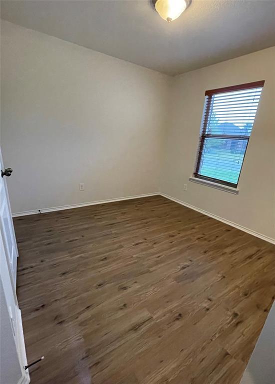 904 Watson Way Pflugerville, TX 78660 - Photo 16 of 16 Empty room featuring dark wood-style flooring and baseboards