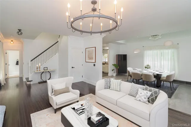 a living room with furniture and a chandelier