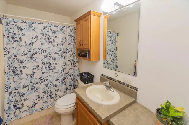 a view of staircase with railing and white walls