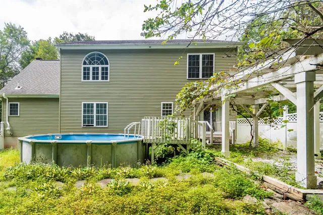 a view of a house with a yard and sitting area