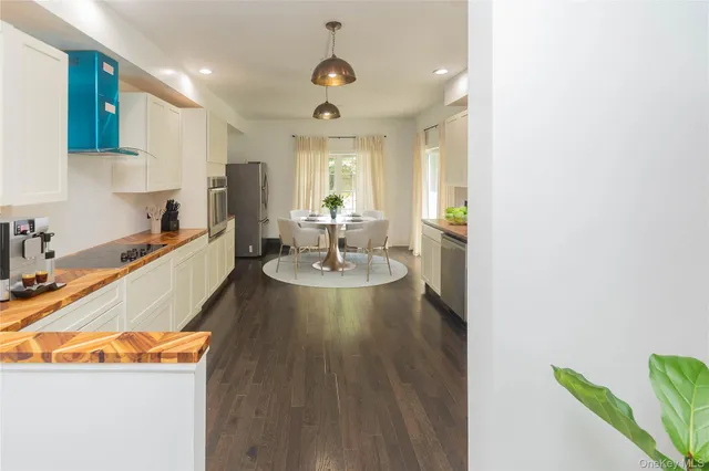 a living room with dining table and wooden floor