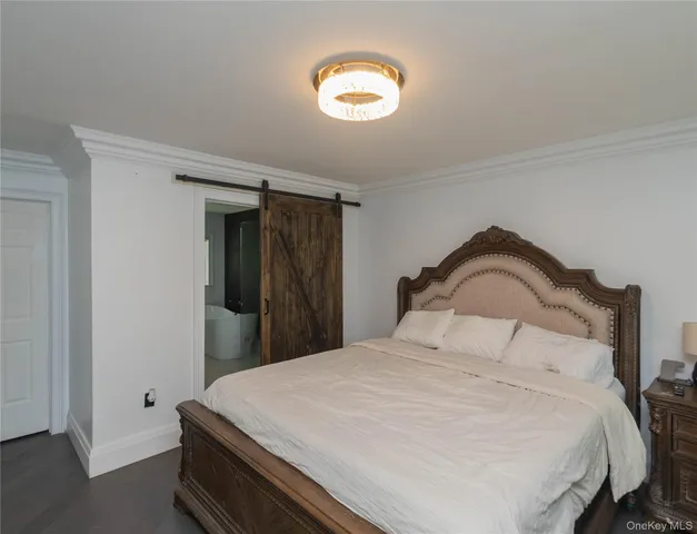 a living room with a couch a fireplace a flat screen tv and a window