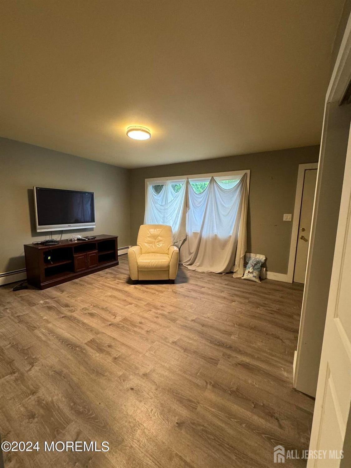 42 East 5th Street Howell, NJ 07731 - Photo 3 of 6 a living room with a flat screen tv and floor to ceiling window