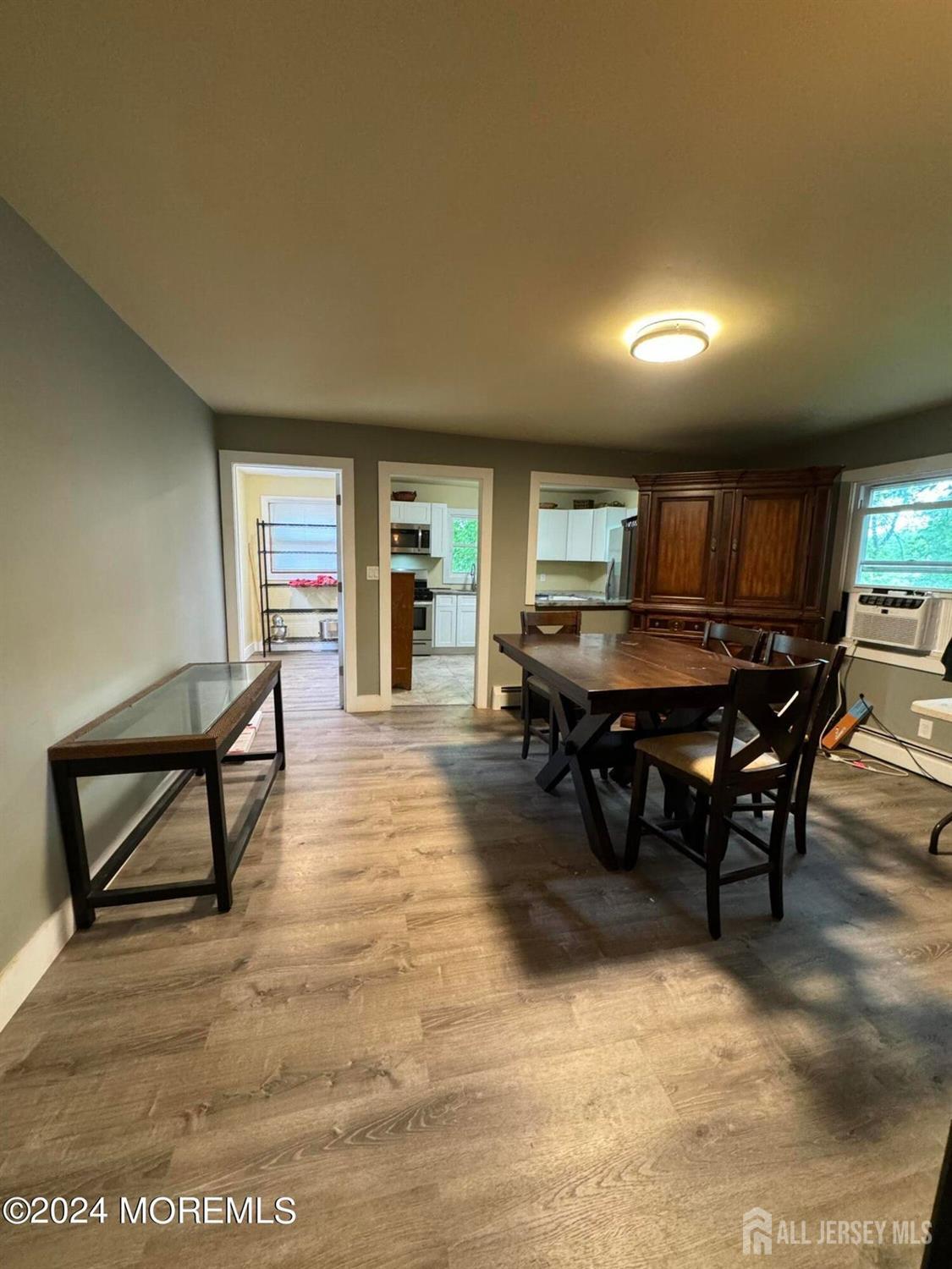 42 East 5th Street Howell, NJ 07731 - Photo 4 of 6 a dining hall with stainless steel appliances a dining table and chairs with wooden floor
