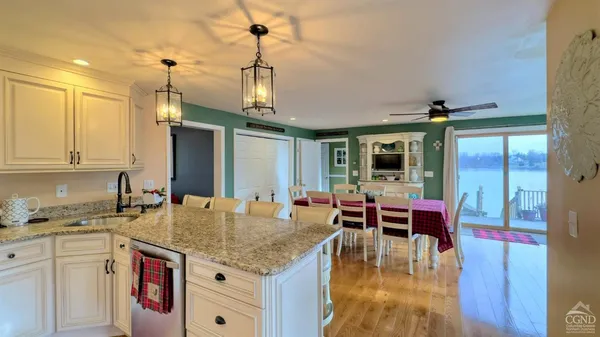 a kitchen with stainless steel appliances granite countertop a sink and a refrigerator