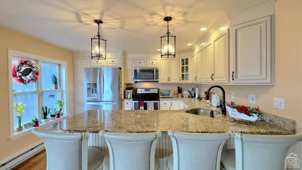a kitchen with sink stove and cabinets