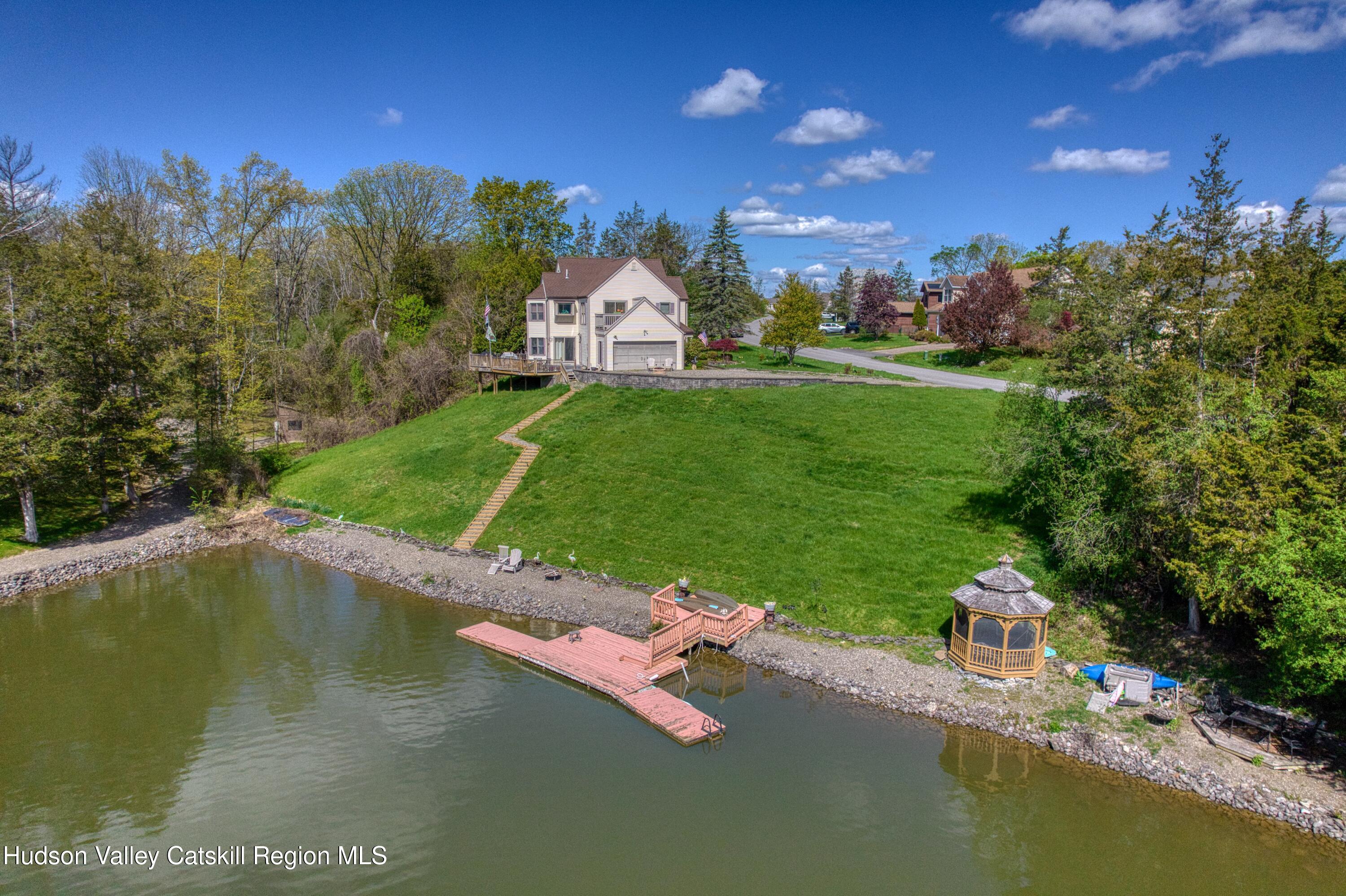 66 Castle Point Road Athens, NY 12015 - Photo 2 of 40 a view of a lake with a house in the background