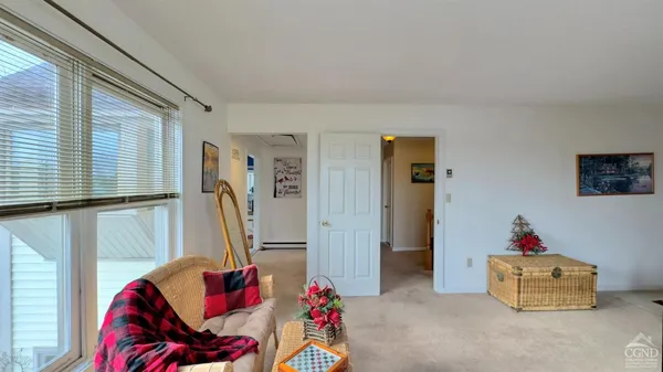 a living room filled with furniture and a window