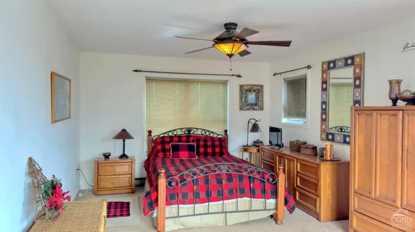 a bedroom with two beds and a window