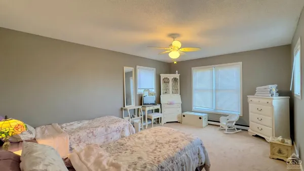 a bedroom with two beds and a window