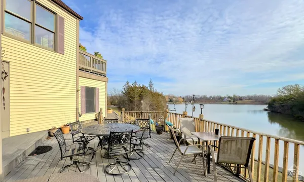 a view of a roof deck with chair and wooden floor