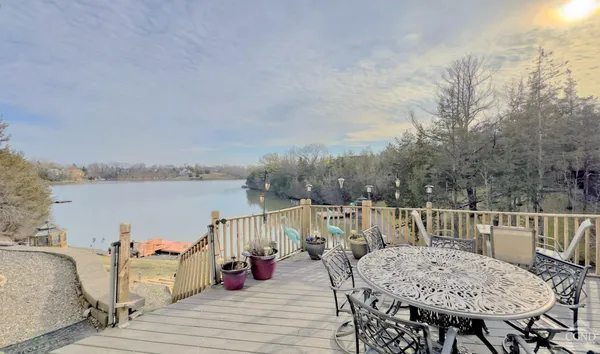 a view of a balcony with furniture and wooden floor