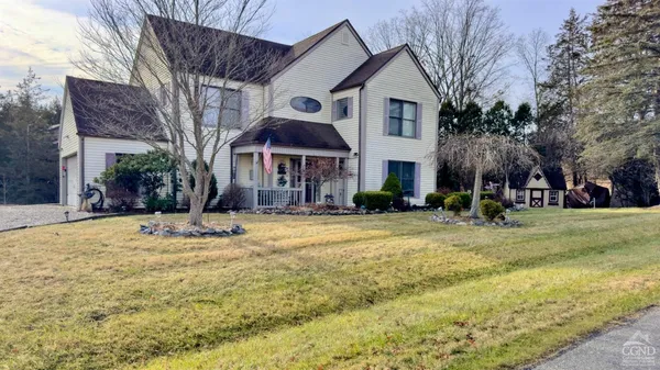 a view of house with yard and swimming pool
