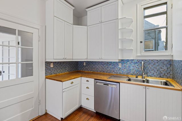 a kitchen with a stove a sink and a refrigerator