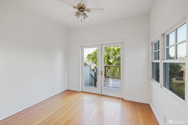 a kitchen with a stove and wooden floor
